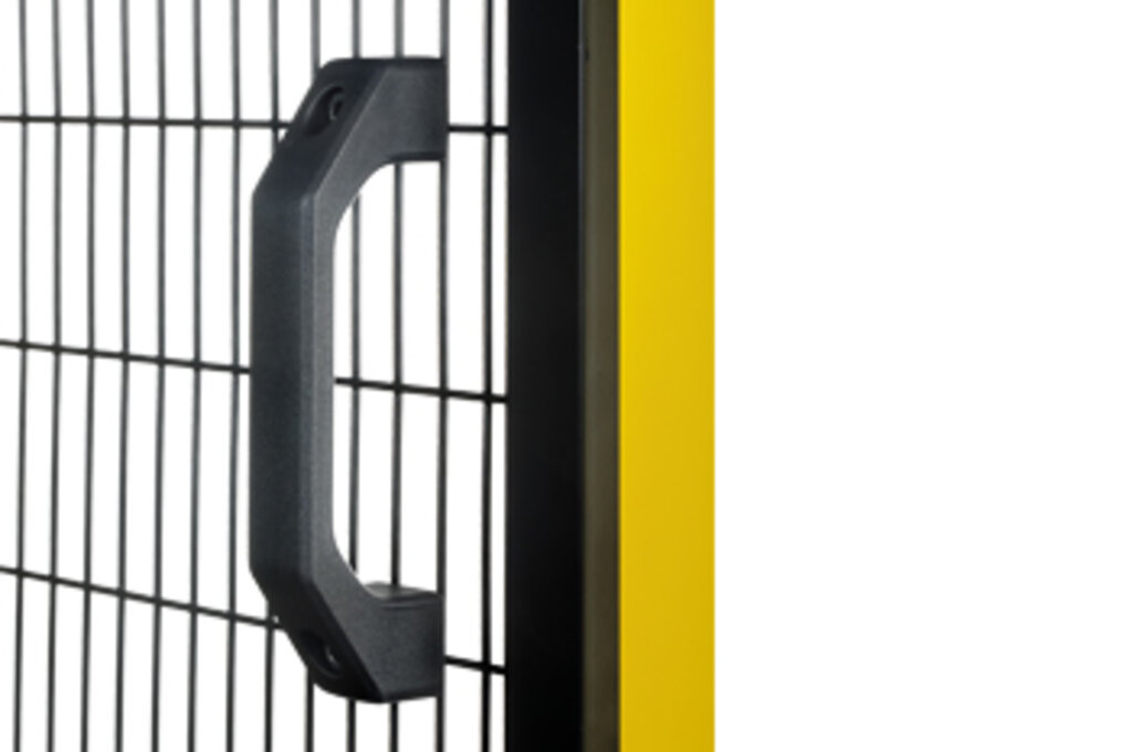 Black metal handle mounted on a wire mesh panel next to a yellow vertical frame