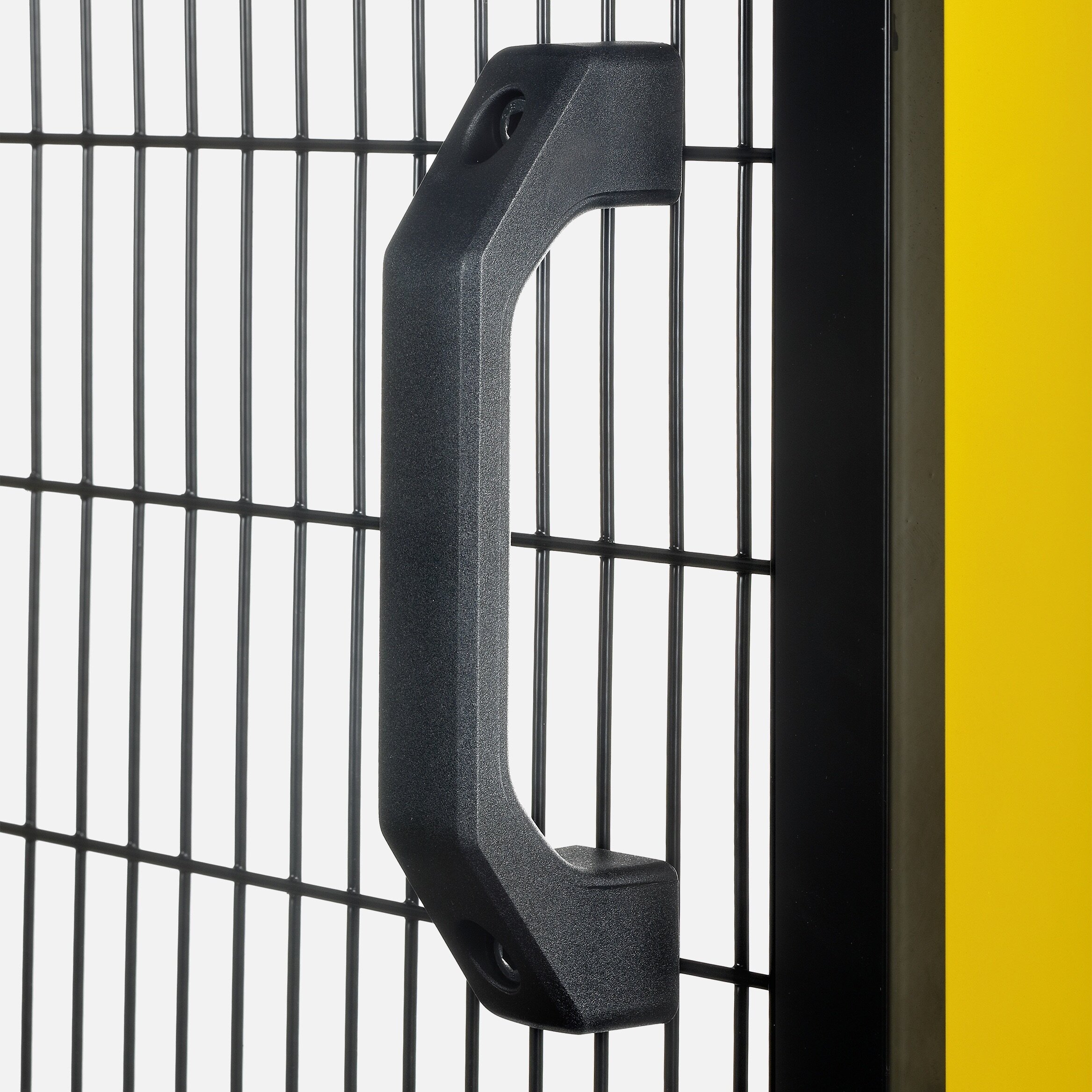 Black plastic handle attached to a black wire mesh safety fence panel with a yellow post beside it