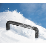 Black aluminium bow-type handle coated with soft plastic suspended in front of snow with flying snow particles against a blue sky.