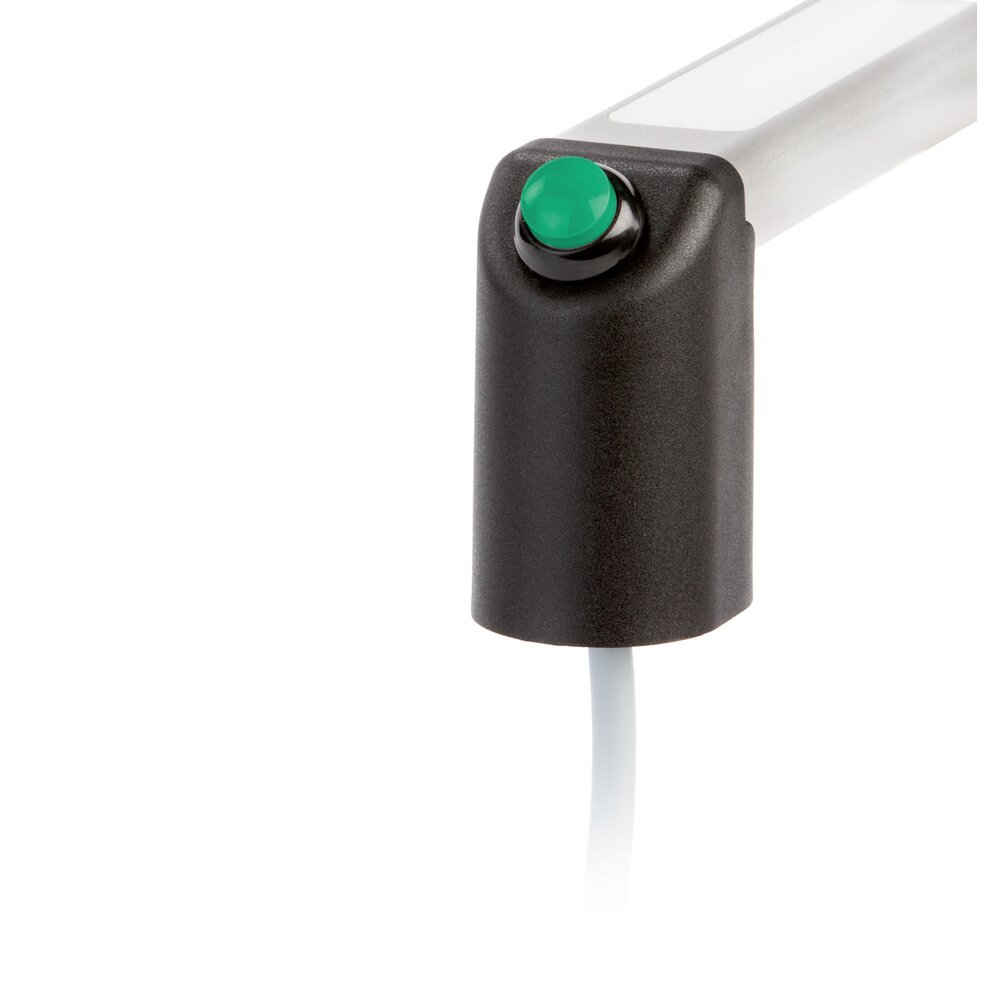 Close-up of a black polyamide handle end with a green raised push button and white cable attached.
