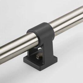 Black polyamide mounting bracket securing a stainless steel tubular handle horizontally on a white background