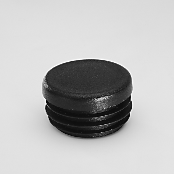 Black plastic pipe plug with flat top and ridged cylindrical body